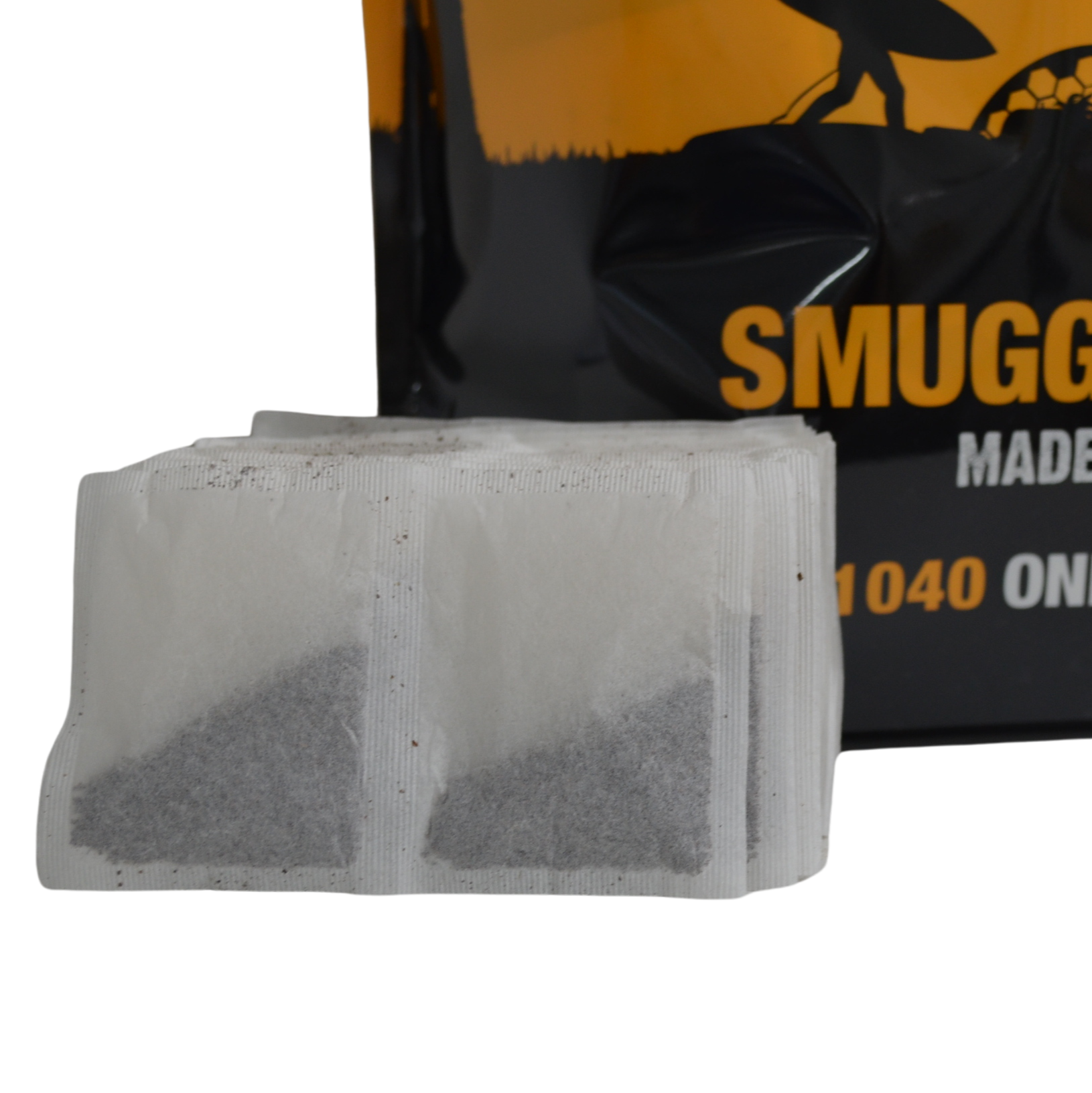 Close-up of Smugglers Brew 1-cup tea bags, showing the square shape and fine black tea inside.